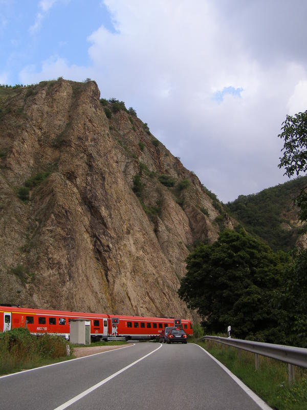 Train in front of a stone wall